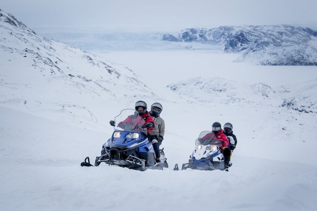 people_drivig_snowmobile_in_winter