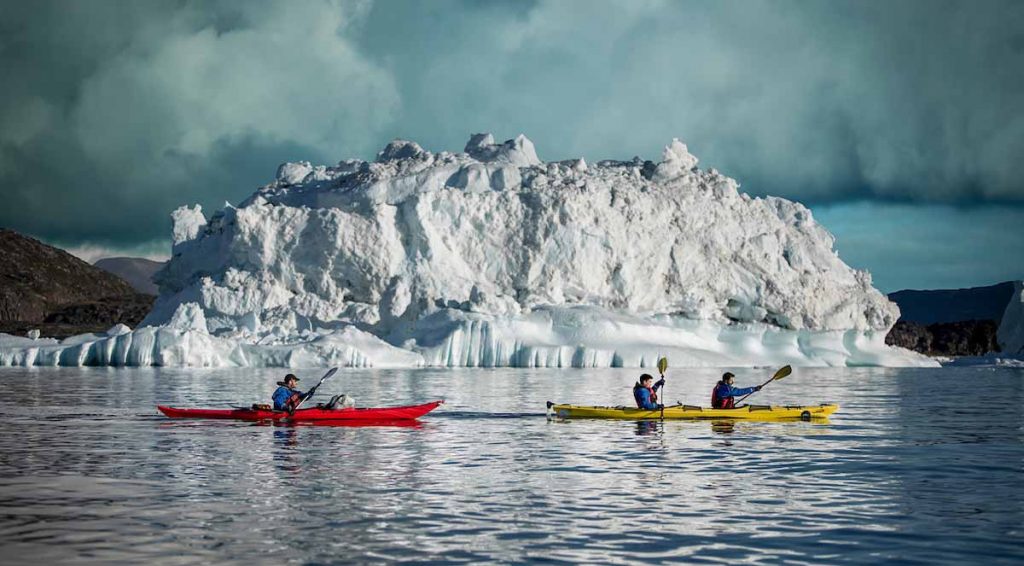 two_kayaks_in_front_of_gigantic_icebergs_near_rodebay